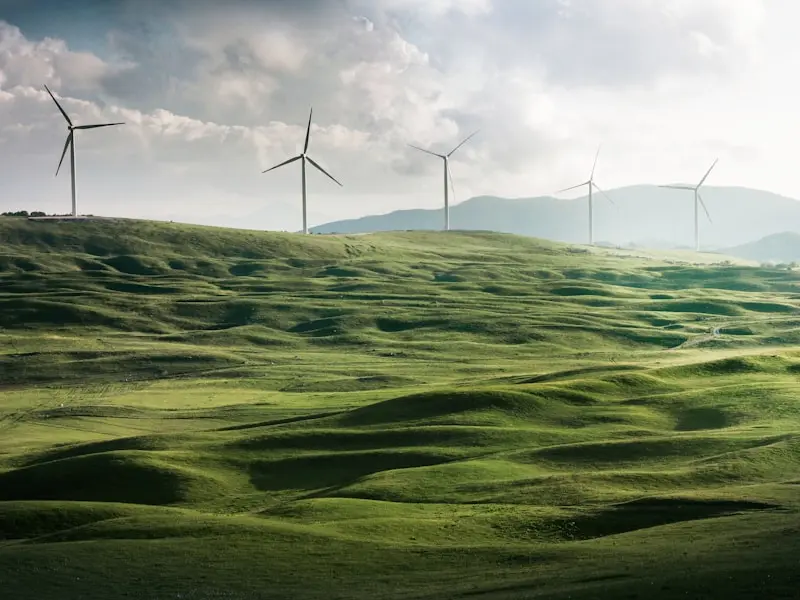 Wind turbines on a green hill